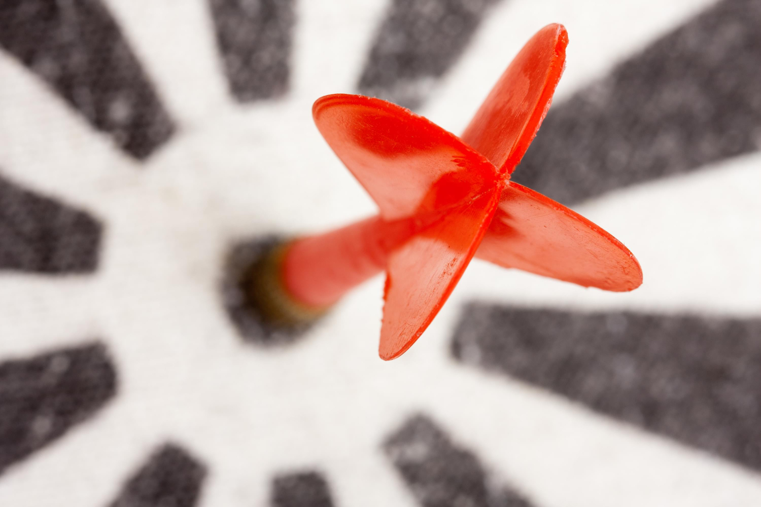 A close-up of a red dart hitting the bullseye, symbolizing achieving career goals with intention