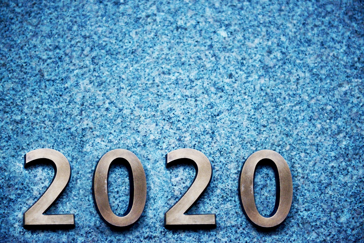 Metallic numbers 2020 on a blue speckled background, symbolizing the new decade's aspirations
