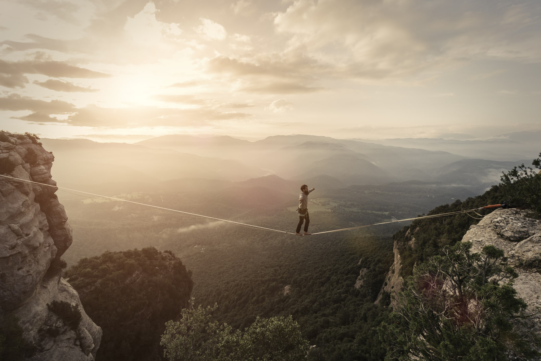 A person slacklining over a vast landscape, evoking the theme of work-life balance